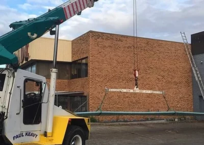 construction crane lift roof sheets to building roof