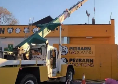 move airconditioning units on top of building with mobile crane