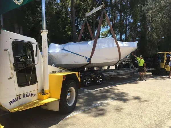 Lifting brand new boat onto trailer Brookvale crane hire boat relocation out of water pittwater northern beaches